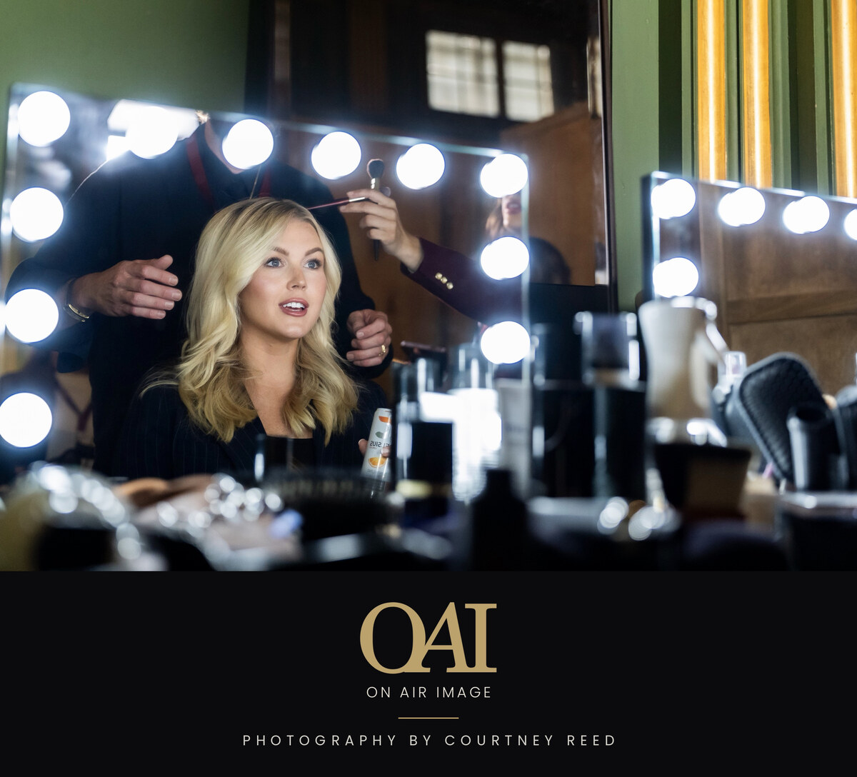 Final hair and makeup check at the mirror before air