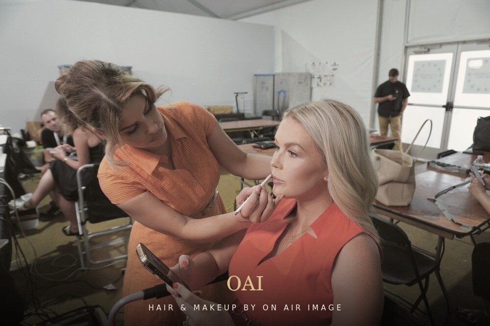 Karoline Leavitt in makeup backstage before an appearance